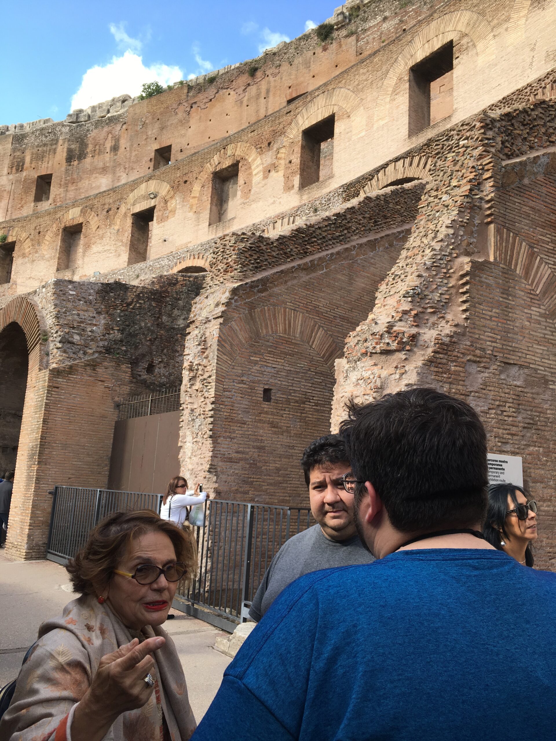 Tour guide leading senior travelers through the Colosseum on an escorted tour