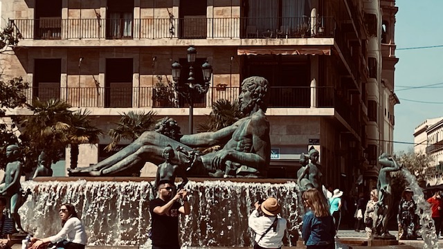 Travelers visiting a historic city square during an escorted vacation