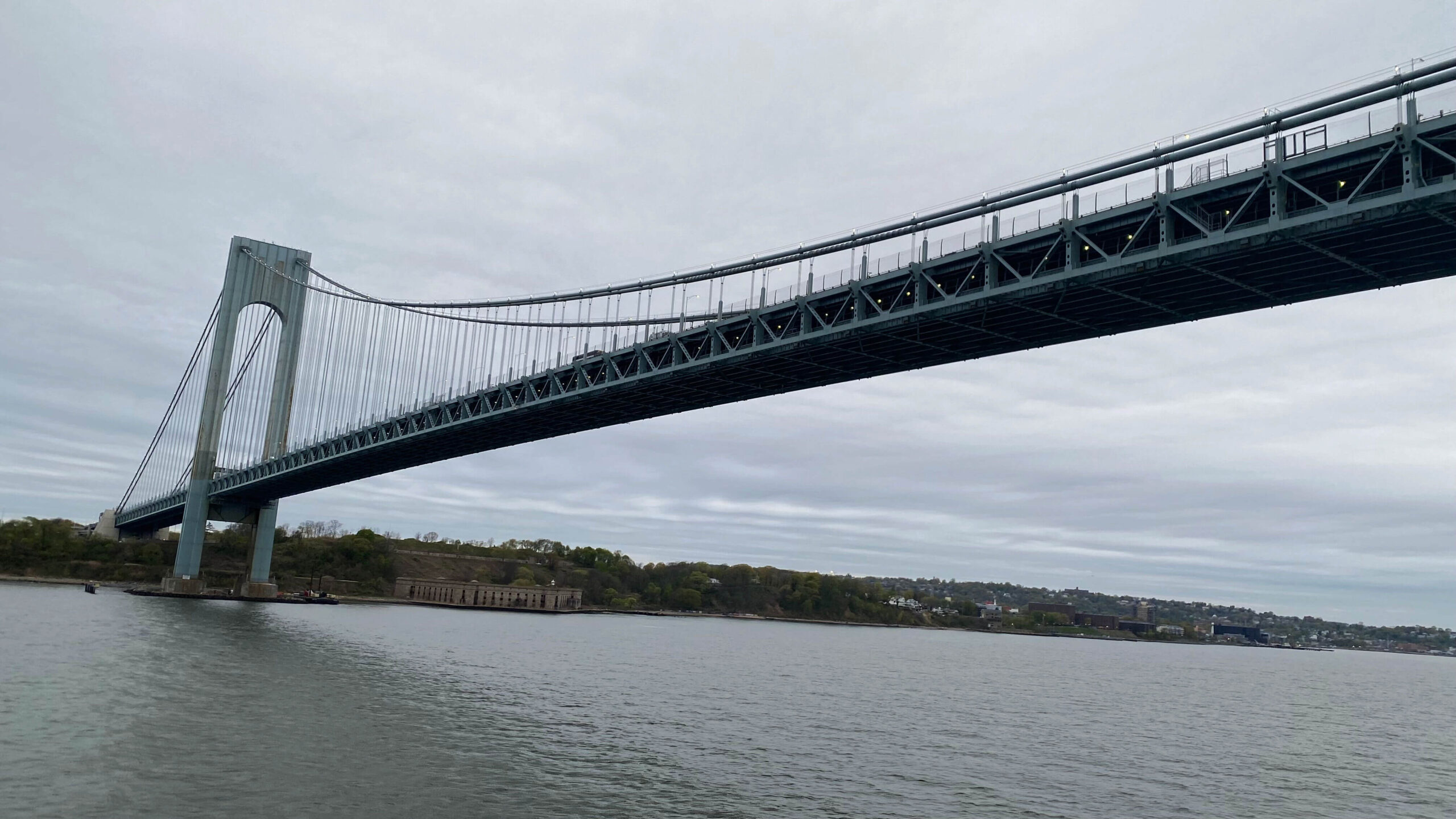 Cruise ship sailing beneath the Verrazzano-Narrows Bridge at the start of a transatlantic cruise from New York